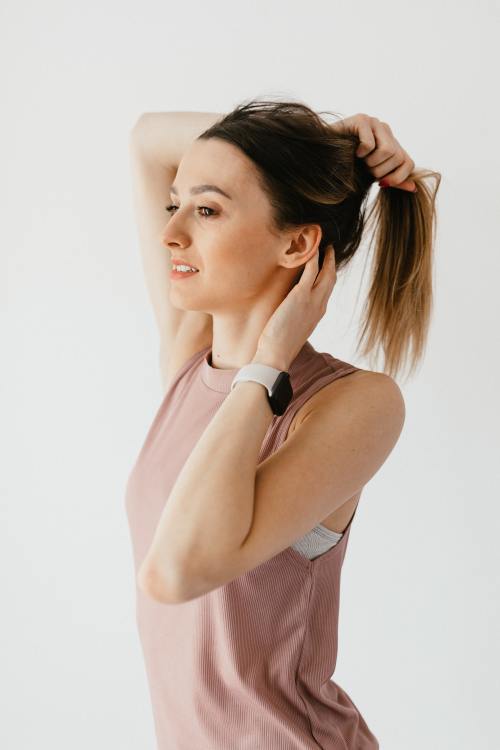 Women Pulling Hair Up into a Ponytail